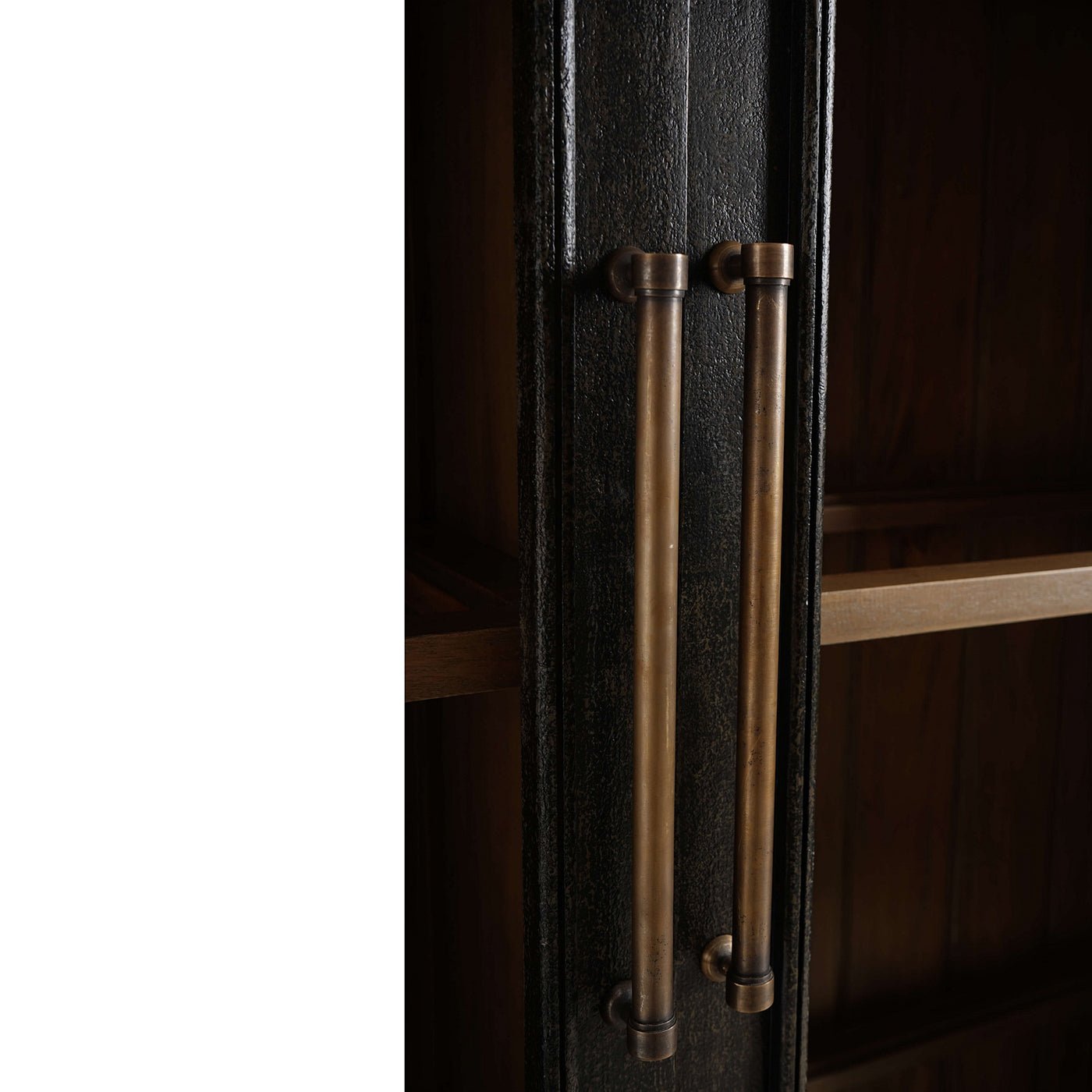 Close-up of cabinet handles on vintage black display cabinet.