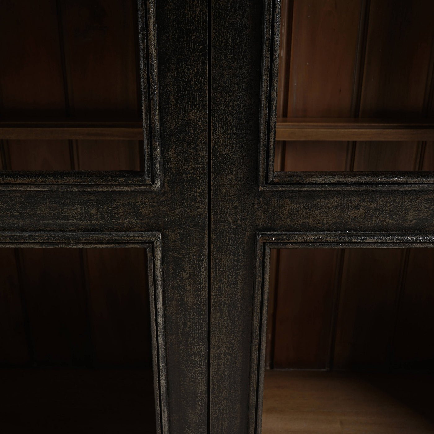 Middle frame detail on vintage black display cabinet.