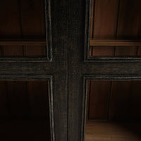 Middle frame detail on vintage black display cabinet.