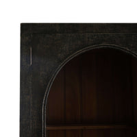 Top arch detail on vintage black display cabinet.