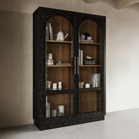 Vintage black display cabinet filled with decor items.