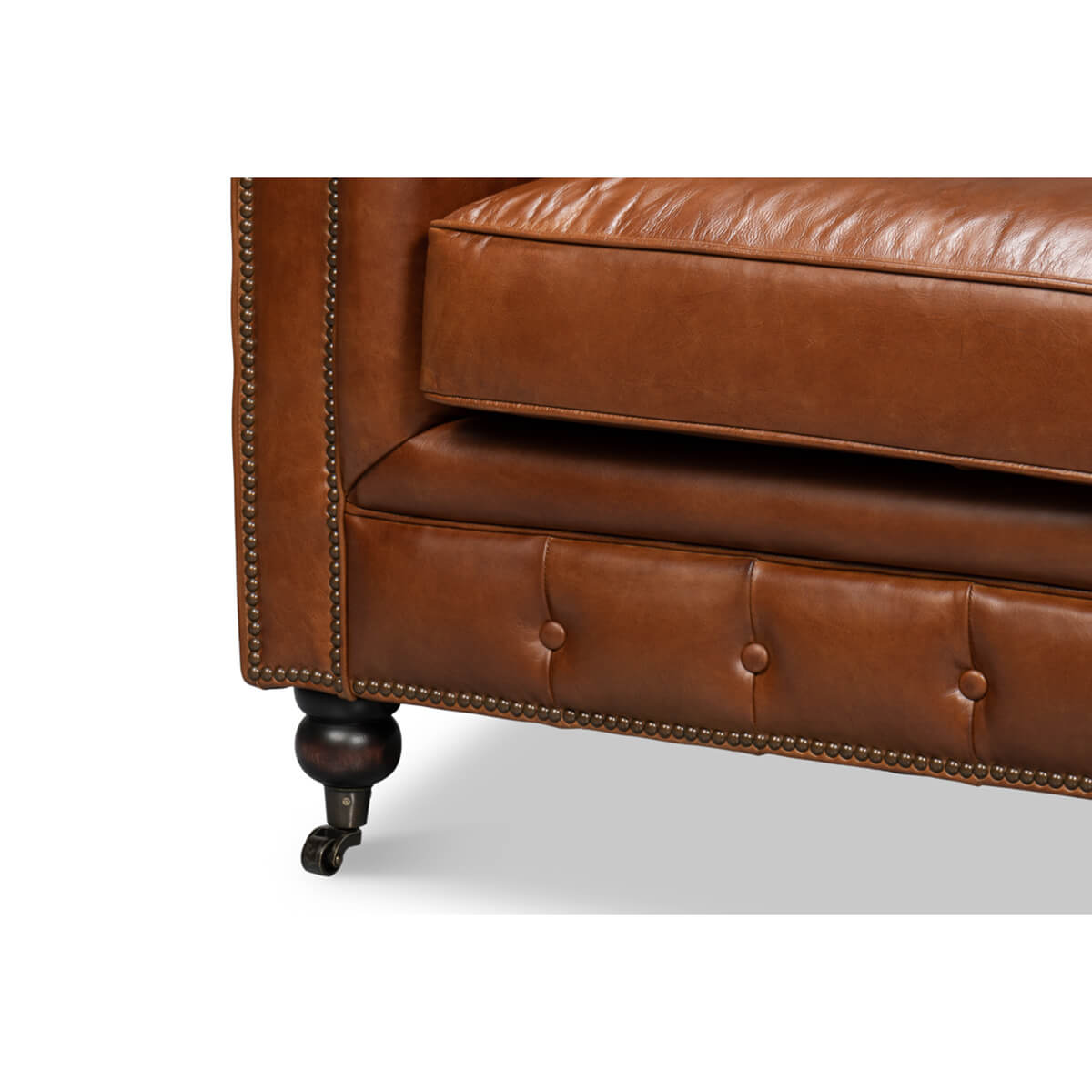 Vintage style Chesterfield sofa, corner and leg detail.