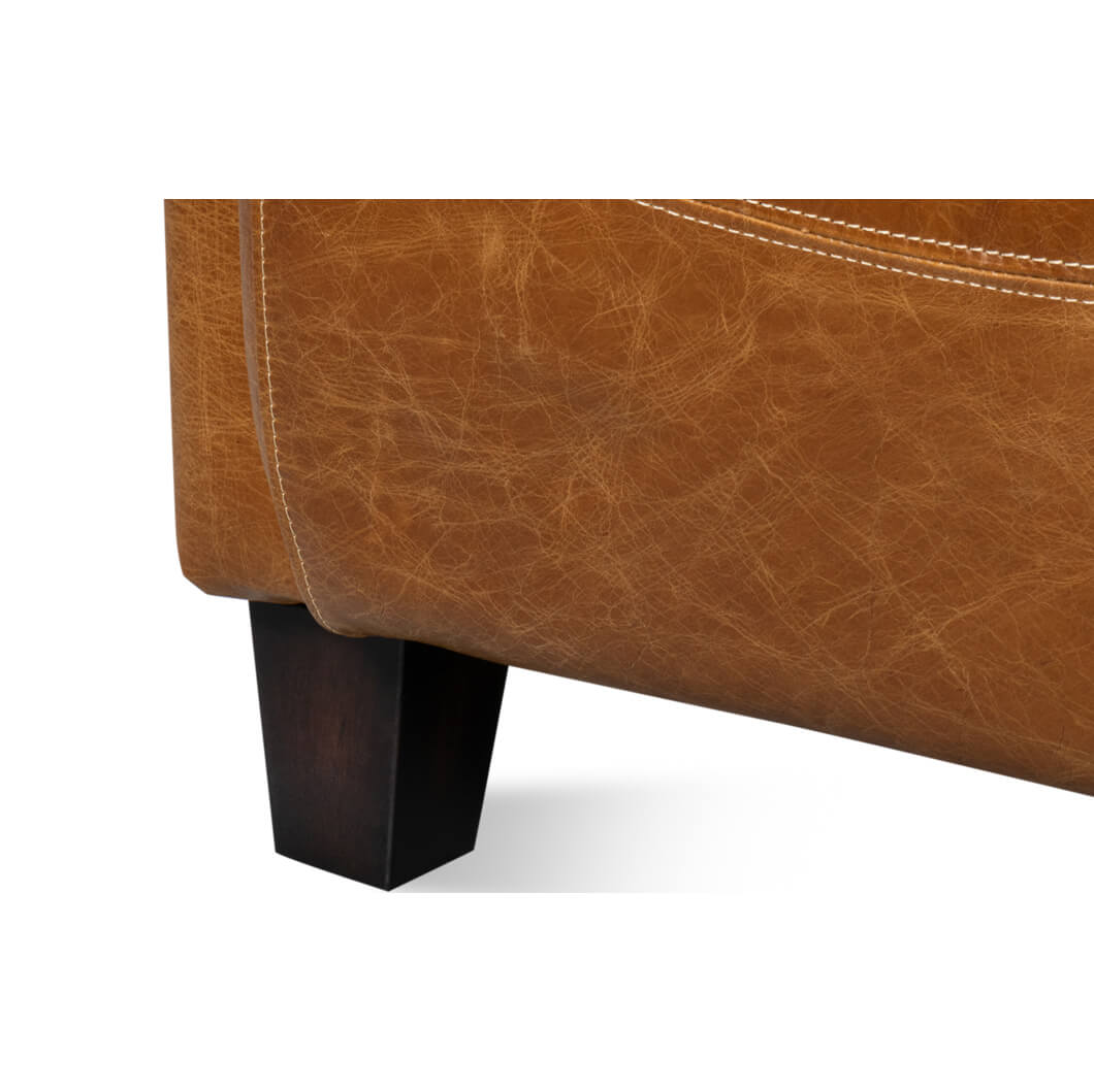 Brown leather club chair front leg detail