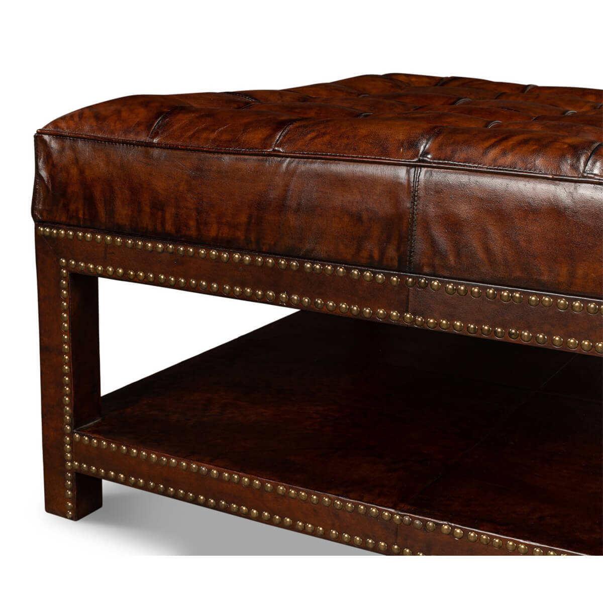 Side angle showcasing ottoman leather and nailhead trim.
