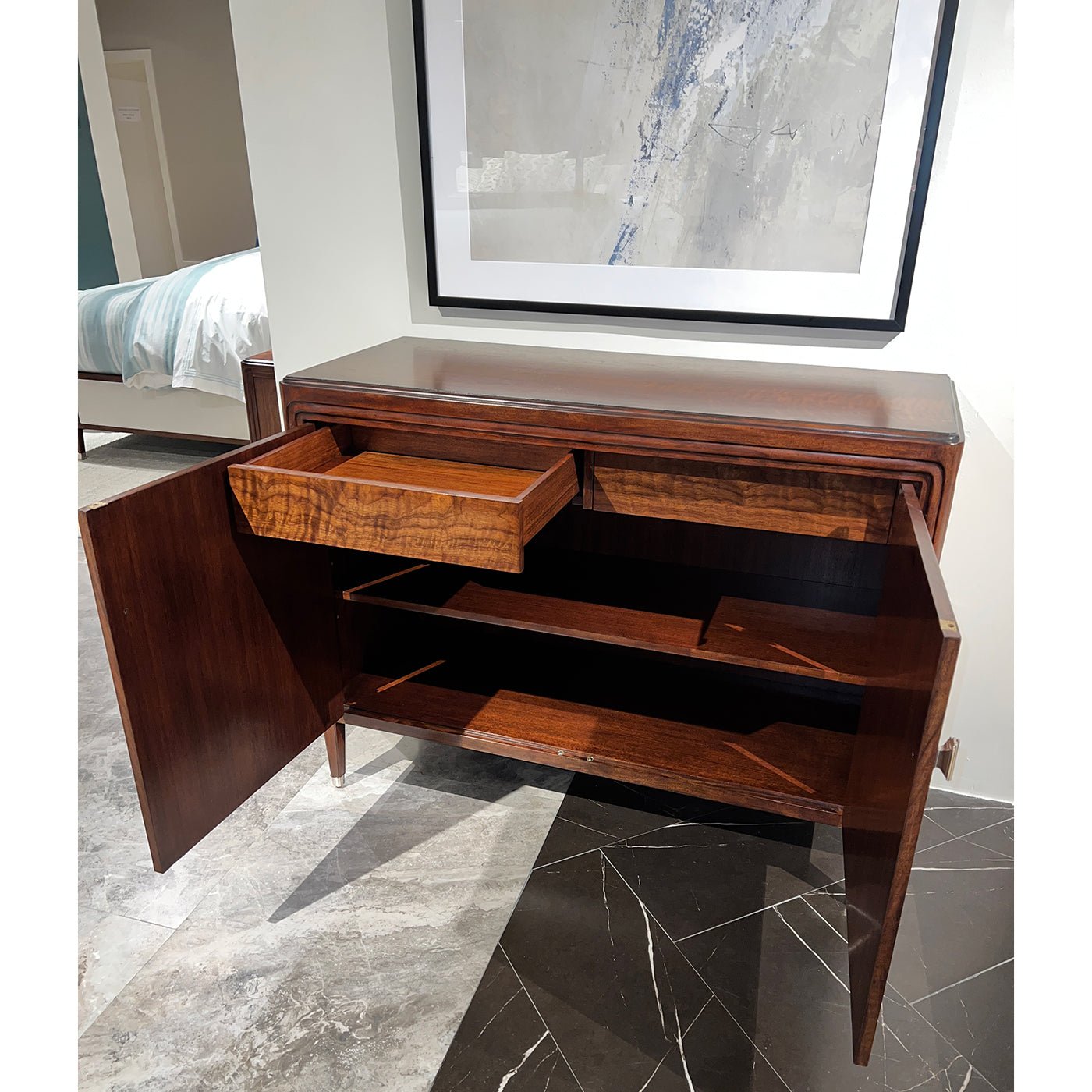 Open walnut Art Deco cabinet showcasing interior shelves and drawers.