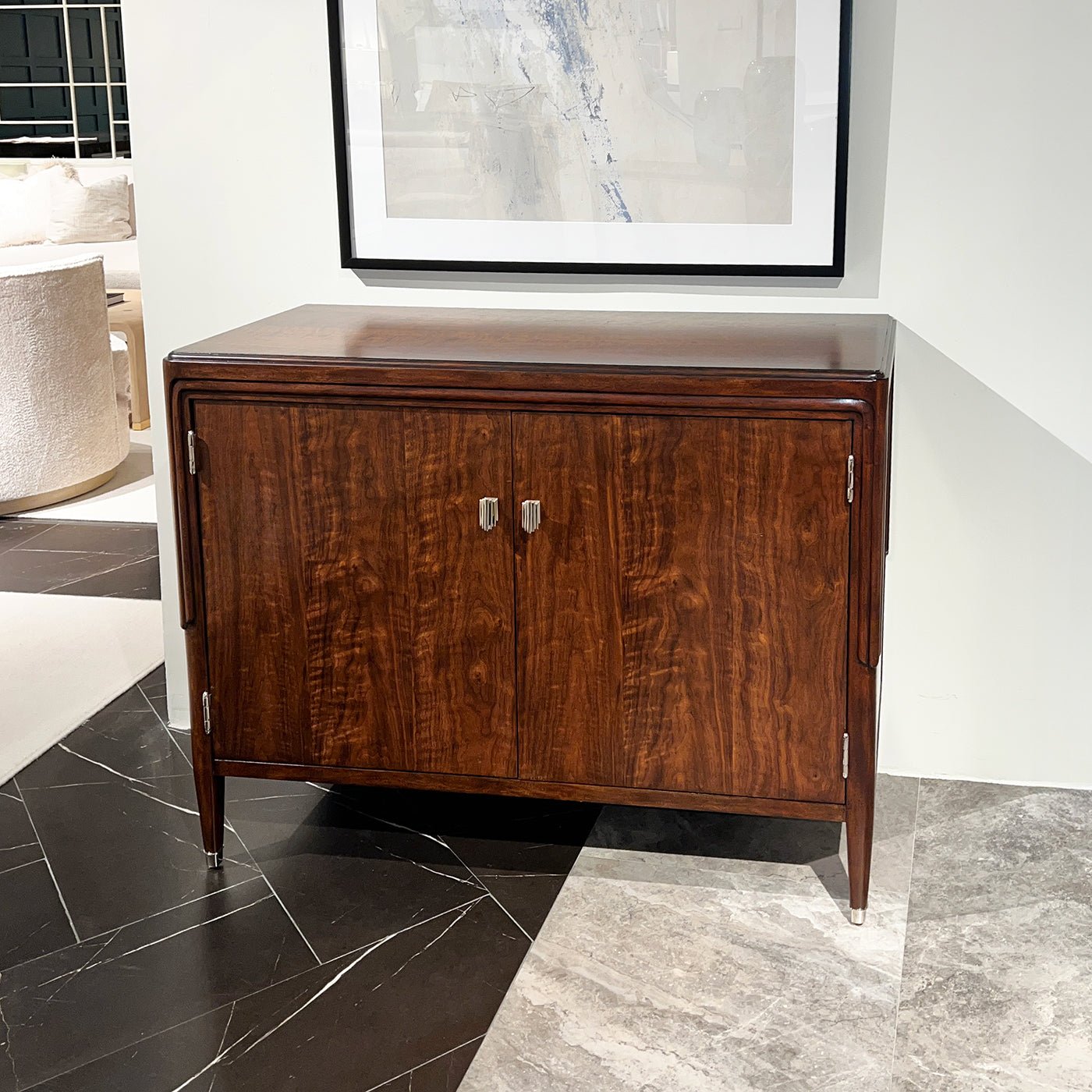 Walnut Art Deco cabinet in modern room setting, marble floor.