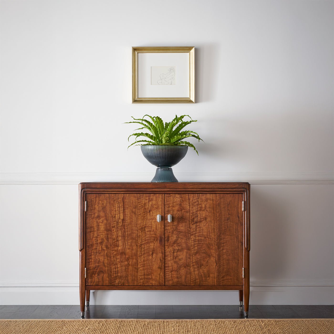 Walnut Art Deco cabinet styled in living room with plant.