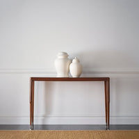 Console table with decorative vases, minimalistic space.