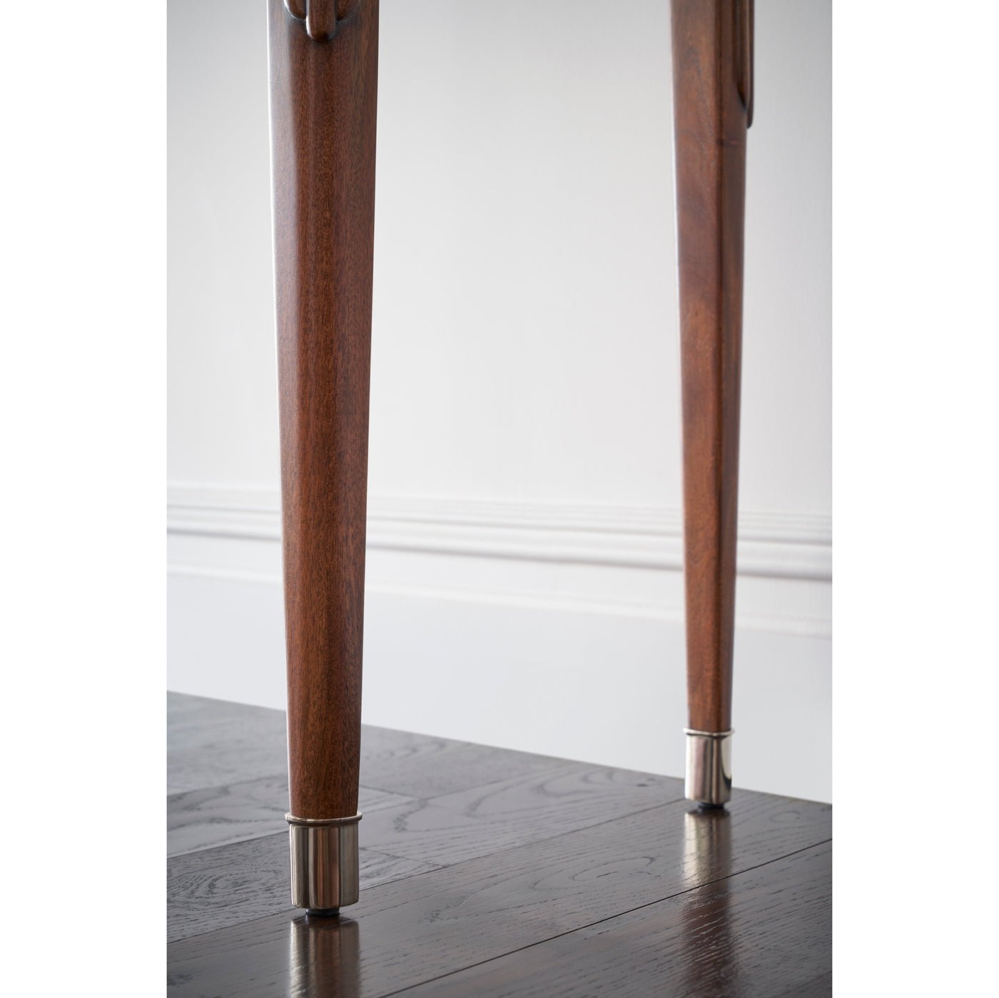Close-up of console table's metal-capped feet.