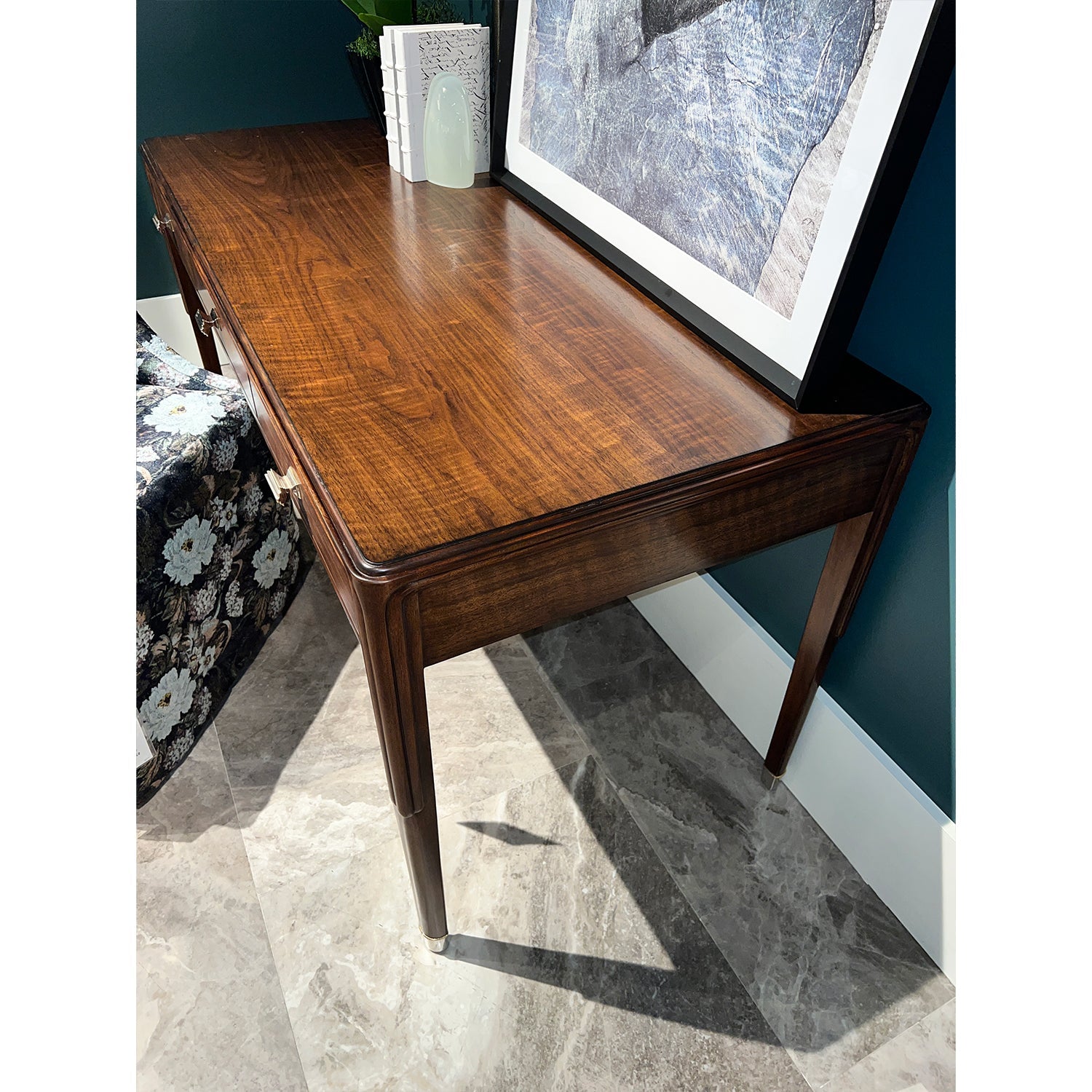 Close-up of walnut desk surface and decor.