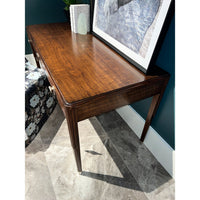 Close-up of walnut desk surface and decor.