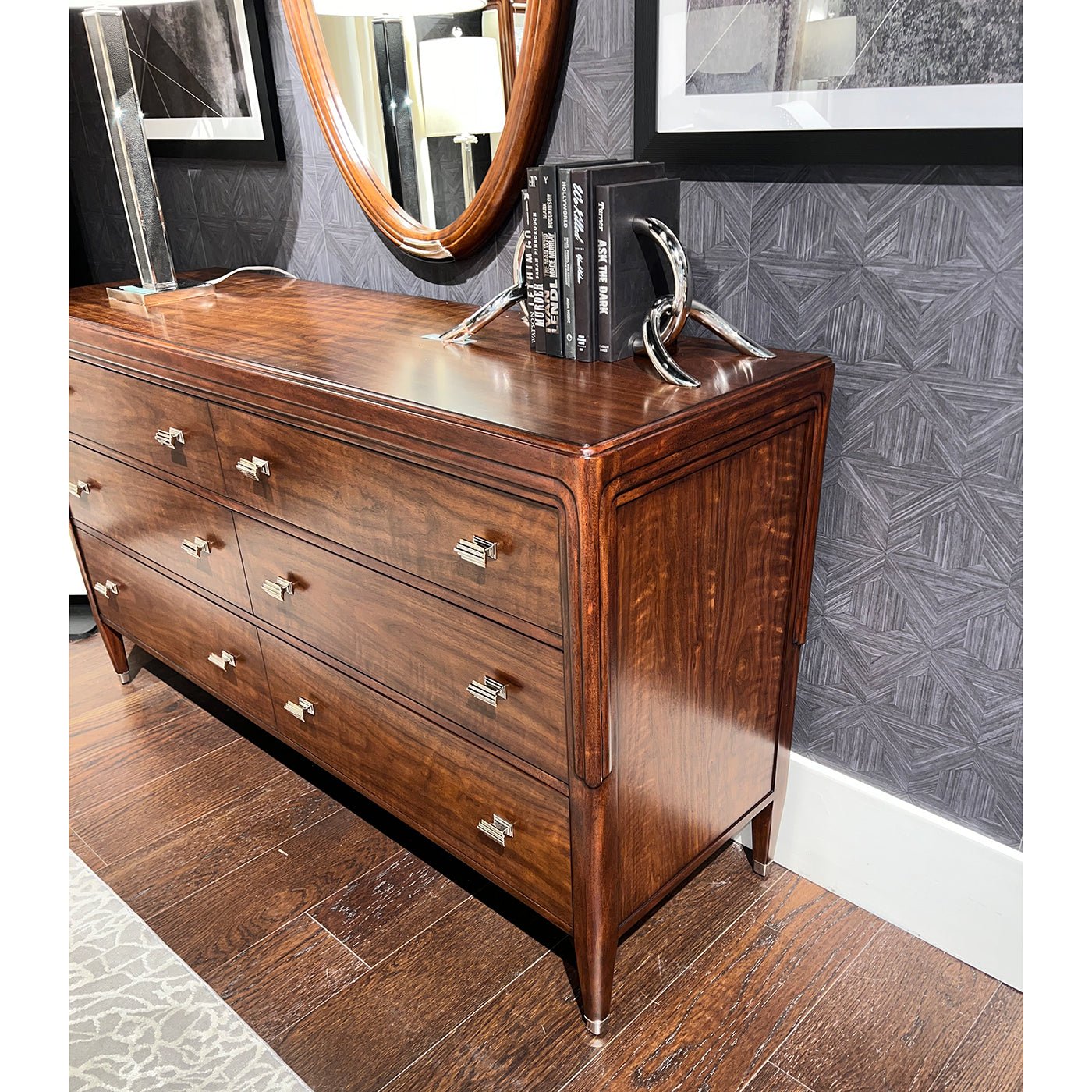 Close-up of walnut dresser, detailed grain, mounted decor.