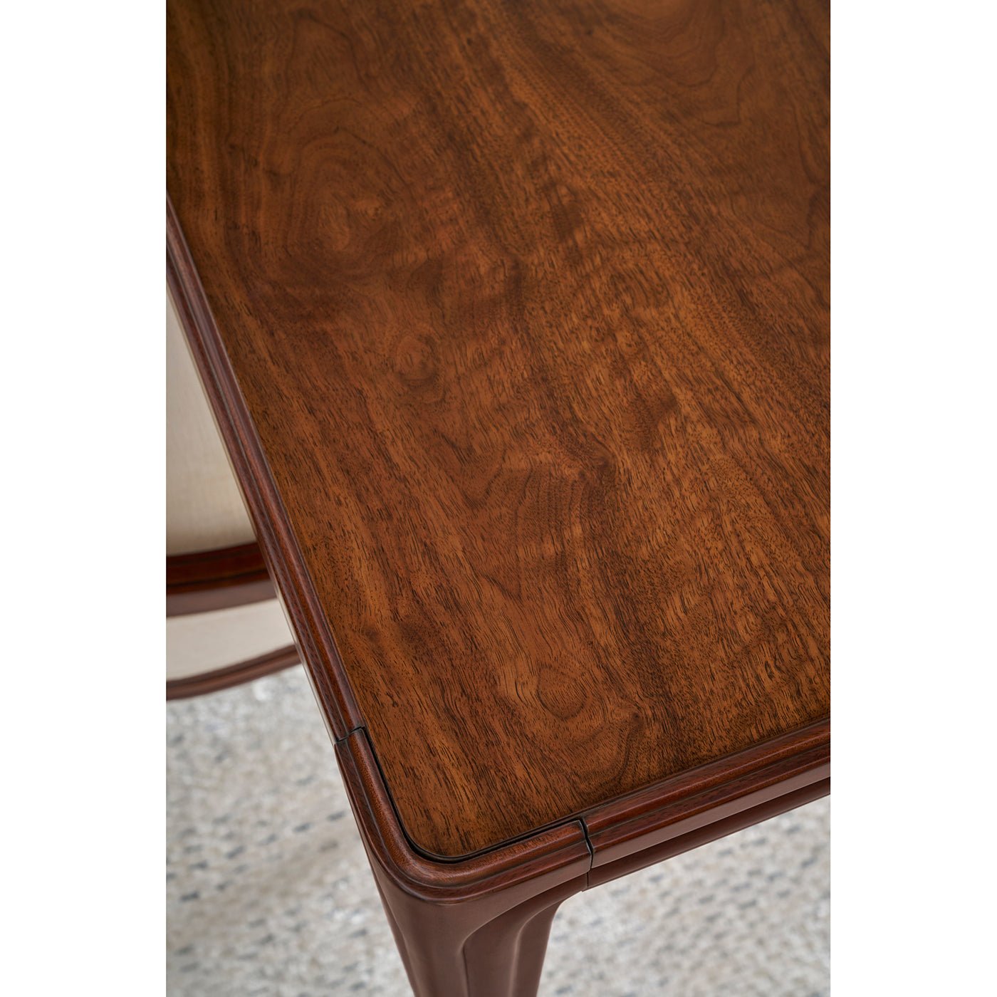 Detailed view of walnut dining table surface.