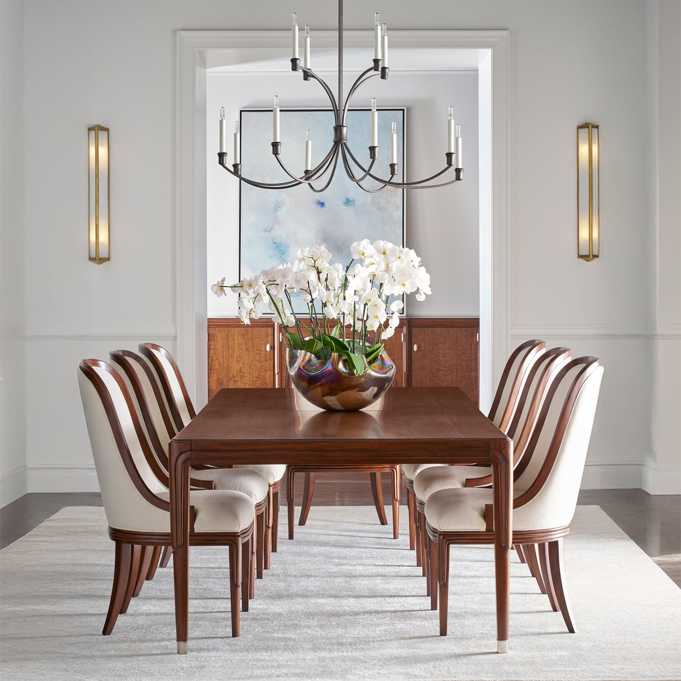 Walnut dining table with chairs in elegant dining room.