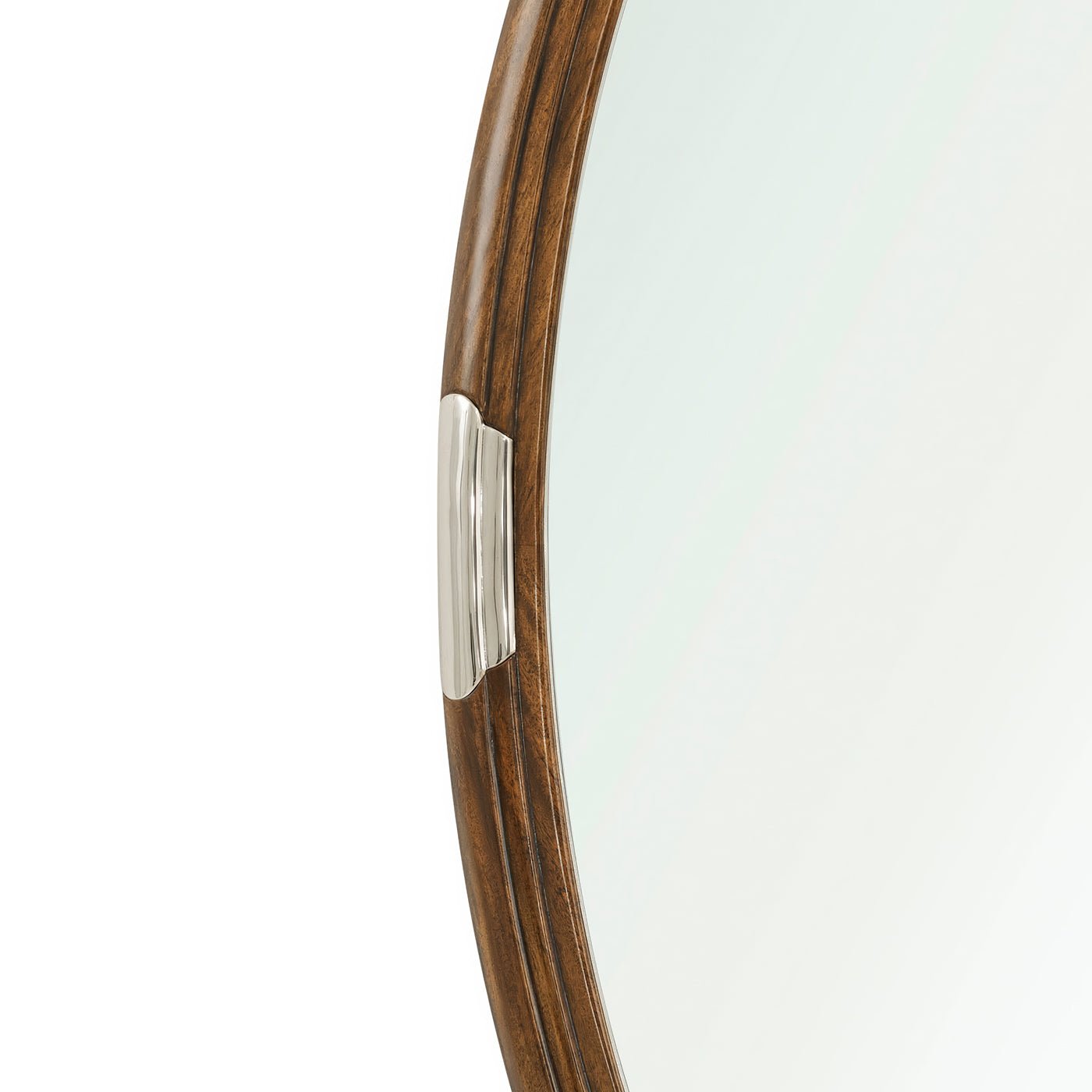 Close-up detail of walnut frame on oval mirror.