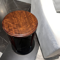 Top view of walnut art deco accent table next to sofa.
