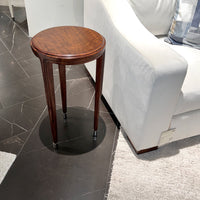 Walnut art deco accent table beside white sofa.