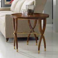 Walnut Art Deco side table by beige sofa, decorative items.