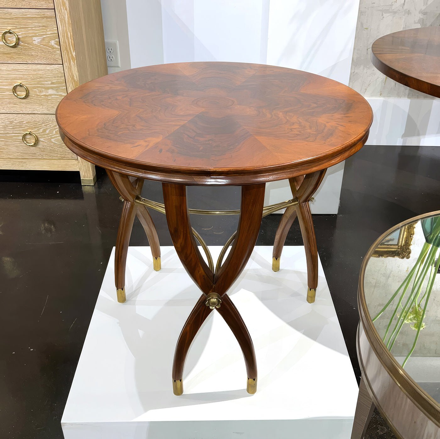 Displayed walnut Art Deco side table on store pedestal.