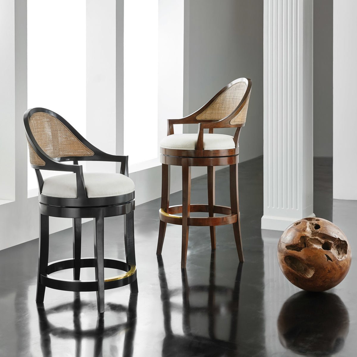 Pair of walnut swivel bar stools in modern setting.