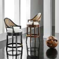 Pair of walnut swivel bar stools in modern setting.