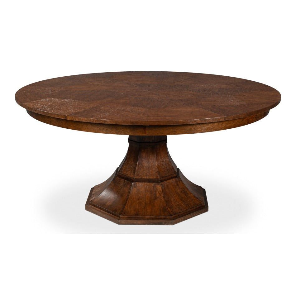 Round expanding dining table in warm brown oak with a herringbone marquetry top and faceted octagonal pedestal base