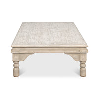 Side view of washed gray lowrise coffee table.