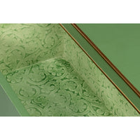 Decorative interior pattern of green nightstand drawer.