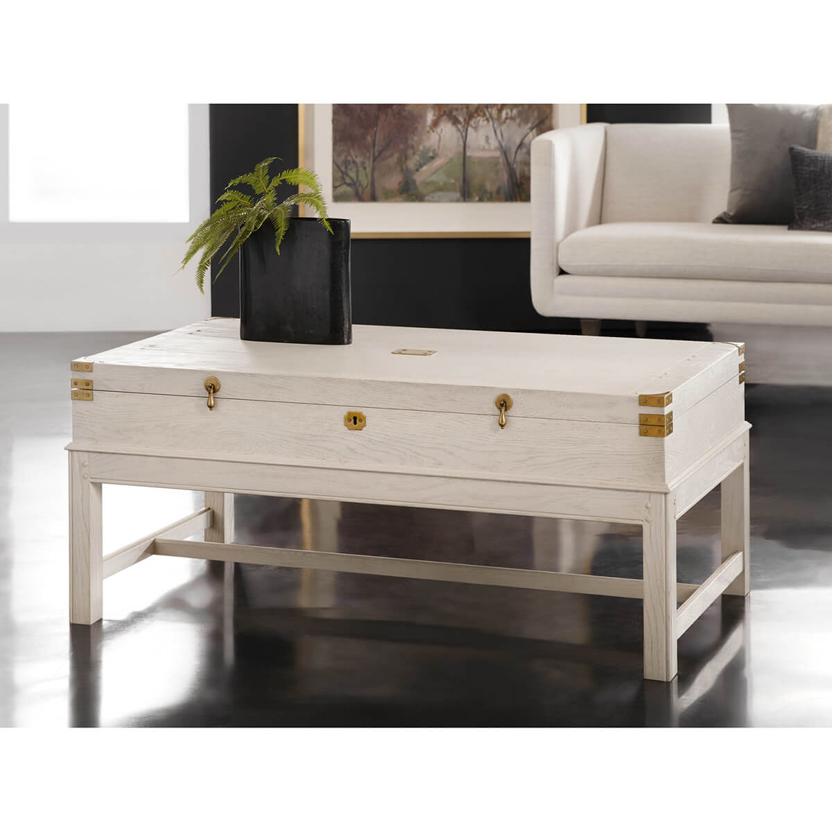 White campaign coffee table in modern living room setting.