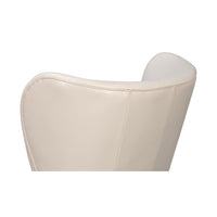 White leather wing chair upper back detail.