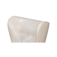 White leather wing chair top corner detail.