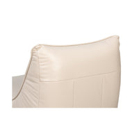 Top back detail of white leather slipper chair