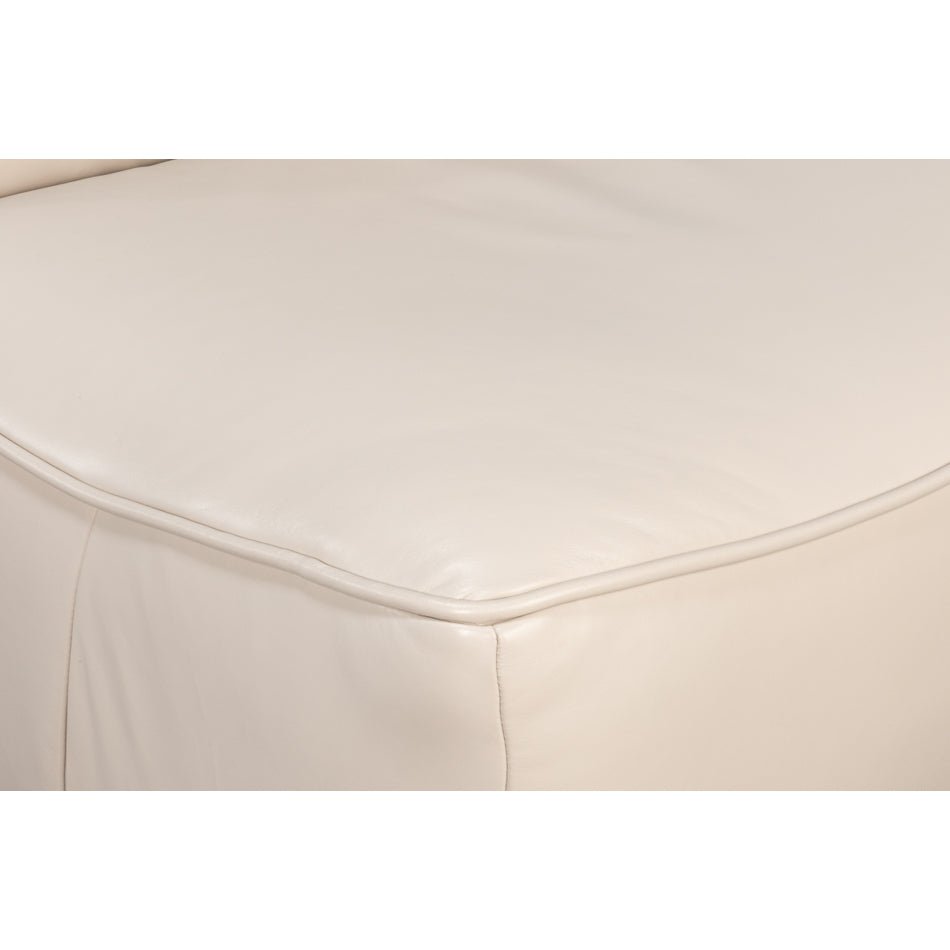 Seat edge of white leather swivel slipper chair