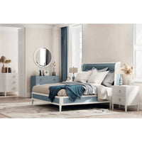 Bedroom scene with modern nightstand beside the bed.