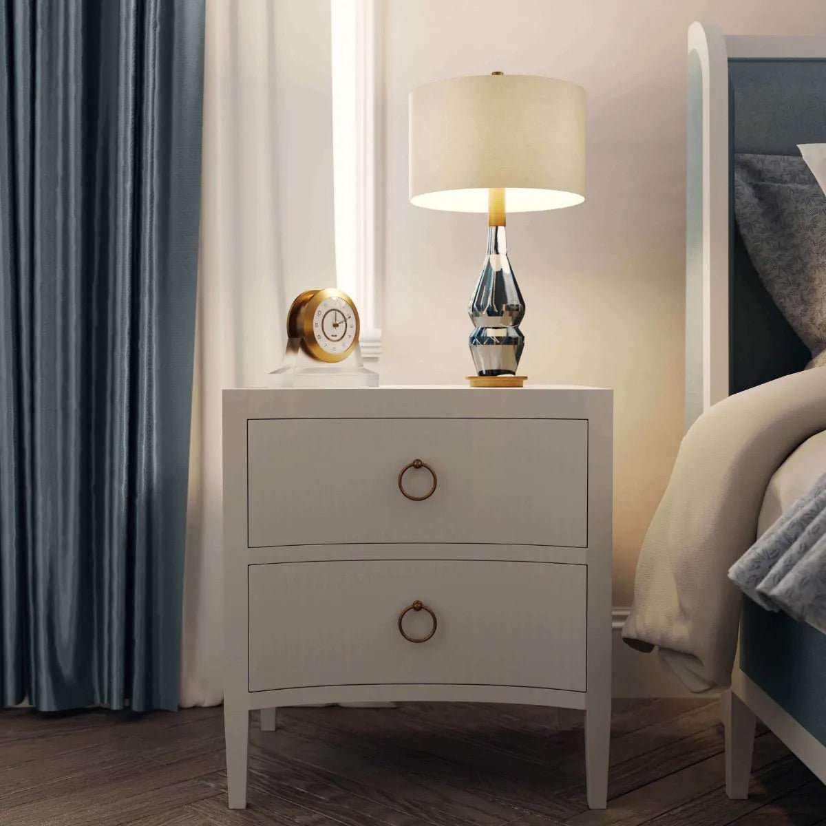 Nightstand with lamp beside bed in cozy interior.