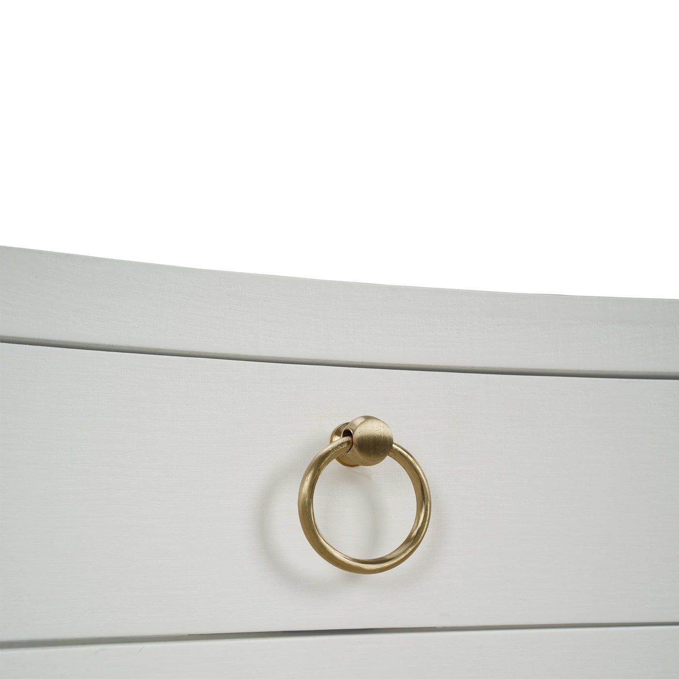 Close-up of gold handle on white linen nightstand.