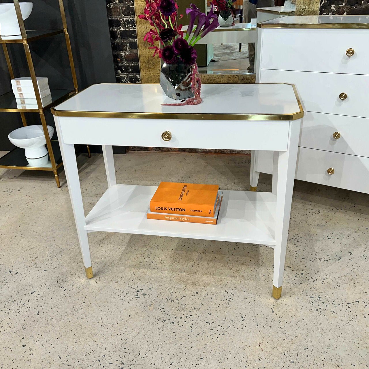 White Mid Century bedside table in showroom setting.