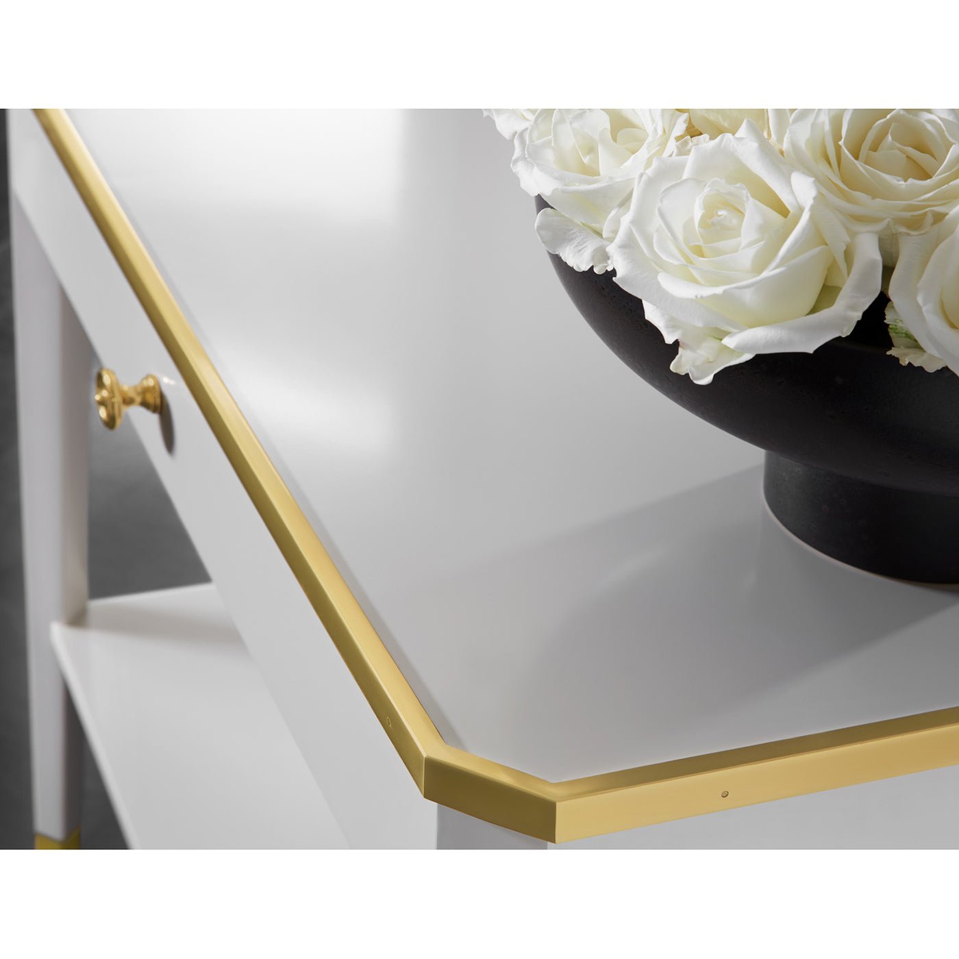Close-up of White Mid Century table with gold trim.