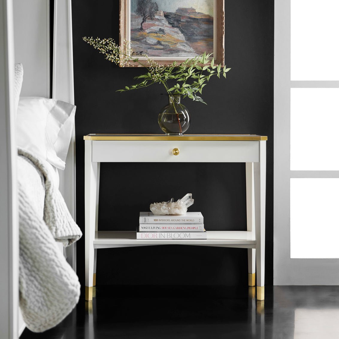 Styled White Mid Century bedside table with decor.