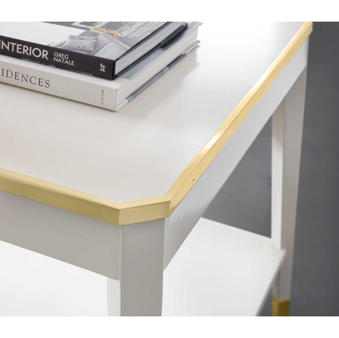 Close-up of gold-edged white mid-century end table top.