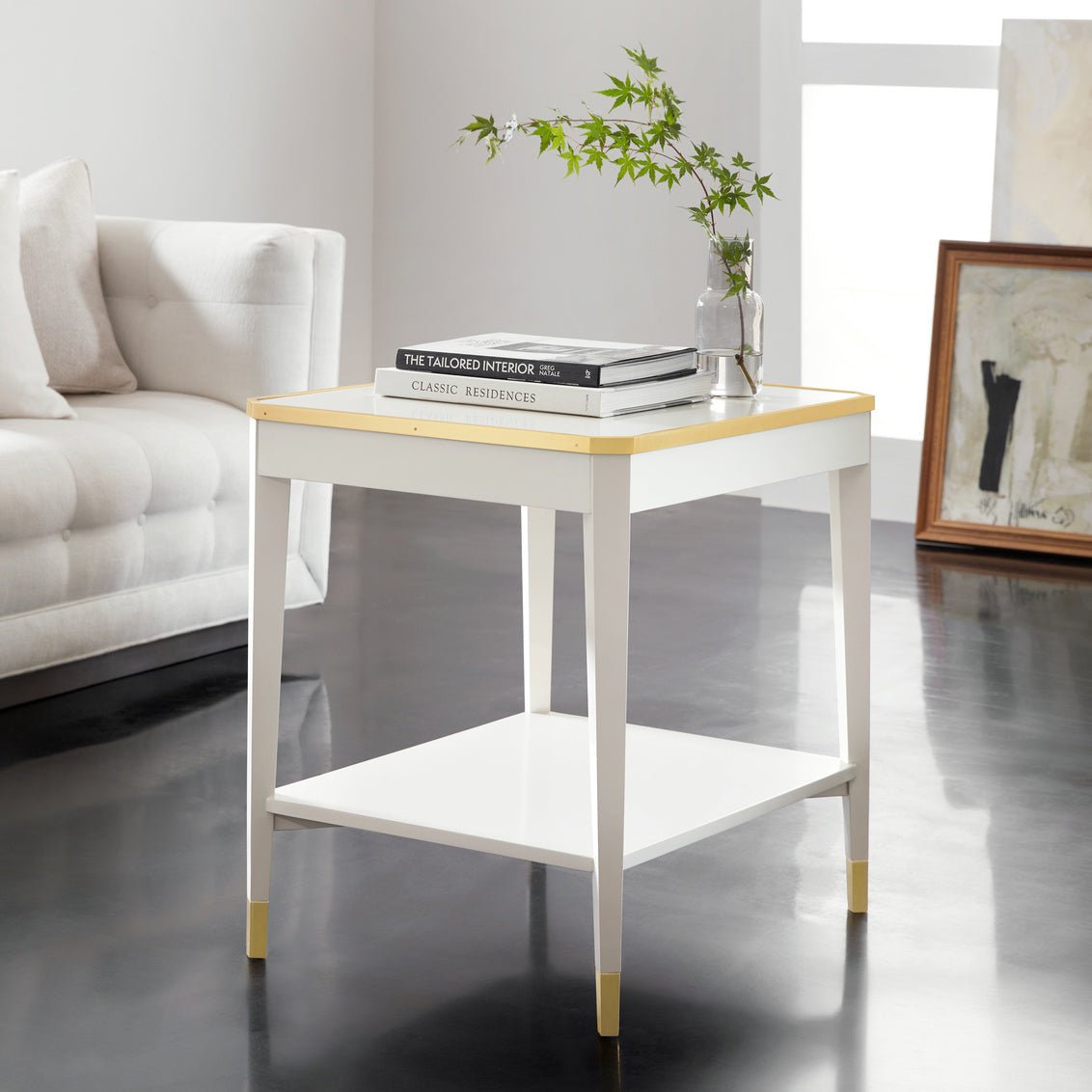 White mid-century end table styled in living room scene.