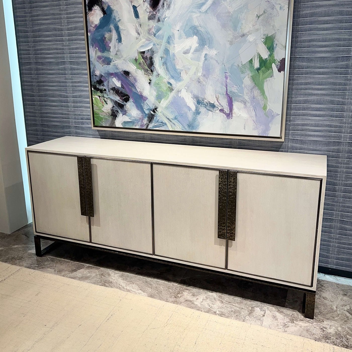 White media cabinet under abstract artwork, room setting