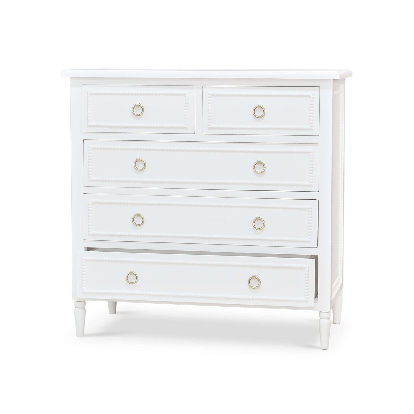 White chest of drawers with bottom drawer slightly open.