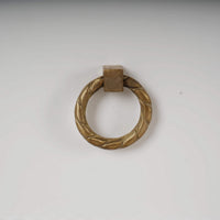 Gold ring handle detail on white dresser.
