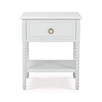 White nightstand front view, beaded legs, drawer closed.