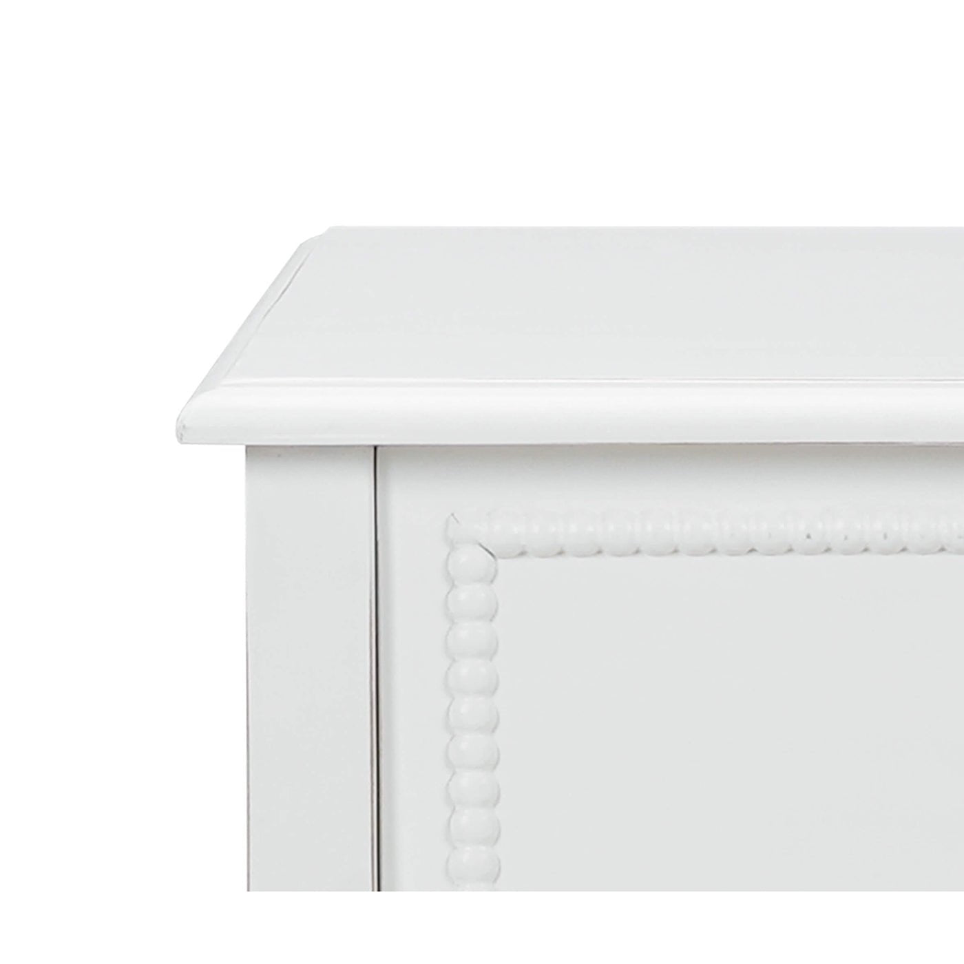 White nightstand close-up, detailed corner, decorative edging.