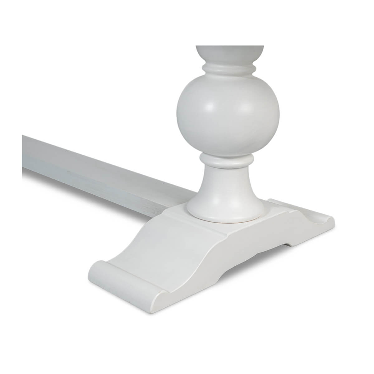 Close-up of curved base of dining table leg.