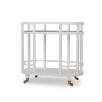 White bar cart with glass shelf, side view.