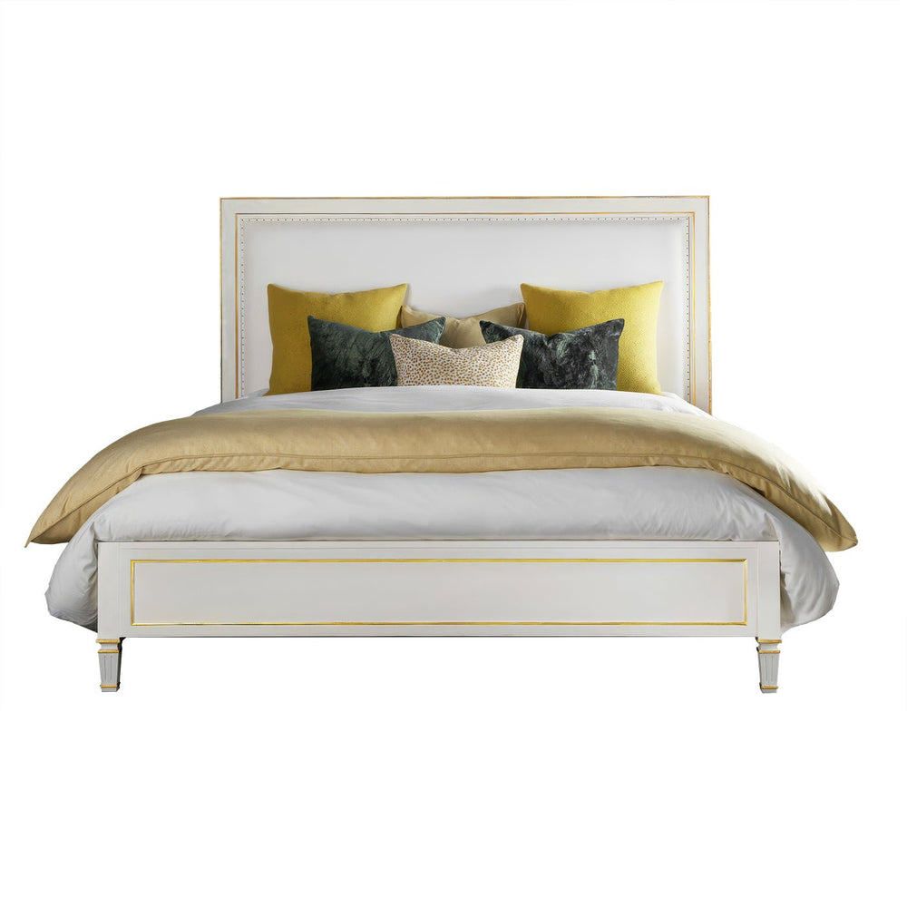 White king platform bed with yellow and gray pillows.