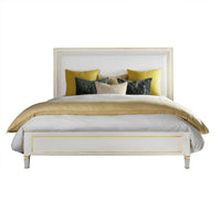 White king platform bed with yellow and gray pillows.